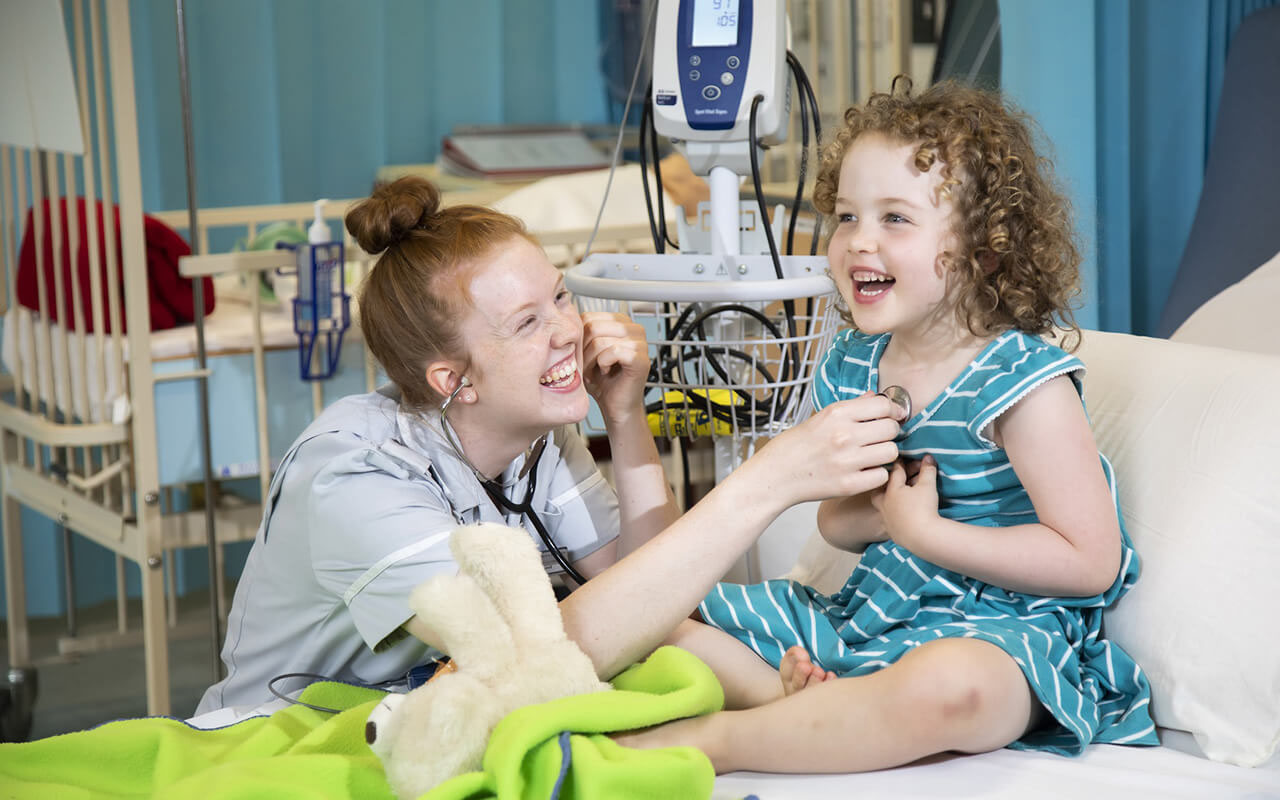 A nurse and child laughing, pr agency brentwood; pr agency braintree; pr agency basildon; pr agency colchester; pr agency chelmsford; pr agency cambridge; pr agency epping; pr agency essex; pr agency harlow; pr agency herts; pr agency ipswich; pr agency suffolk; pr southend; pr thurrock; pr norfolk; commercial photographer colchester; commercial photographer essex; charity pr; event pr; tourism pr